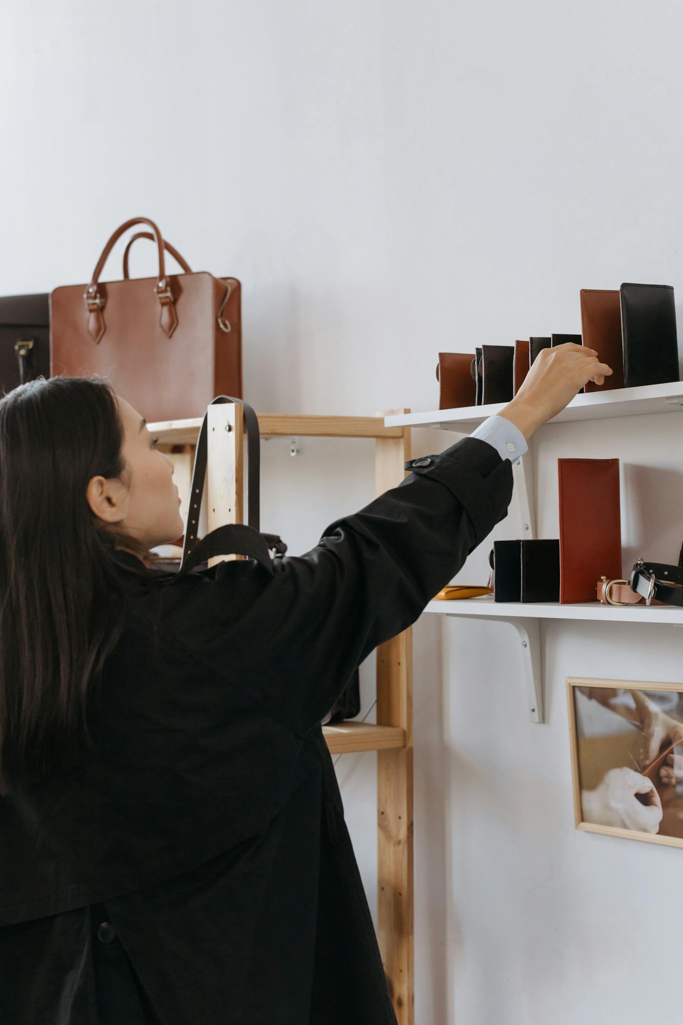 woman browsing leather bags and wallets in